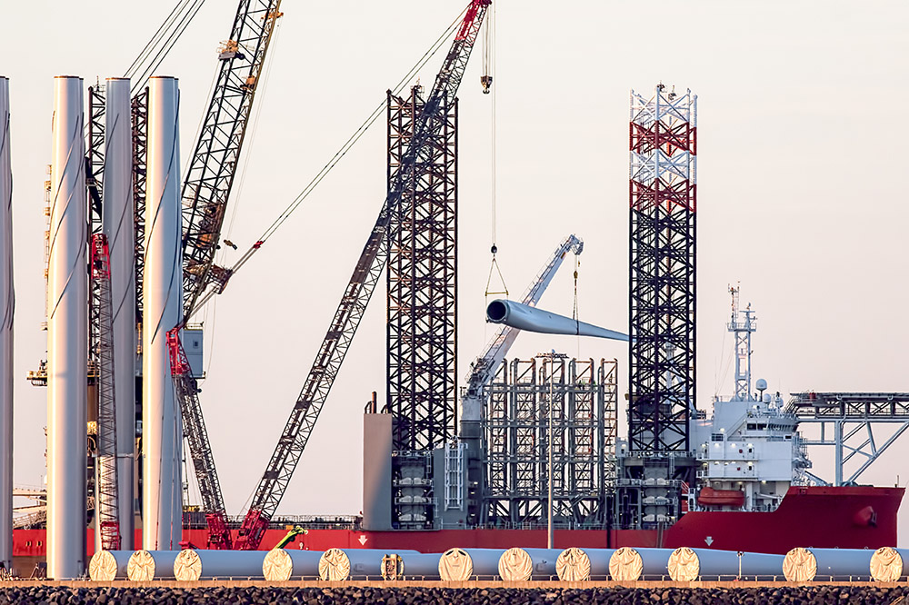 Offshore wind turbine blades and towers at a port in Great Yarmouth