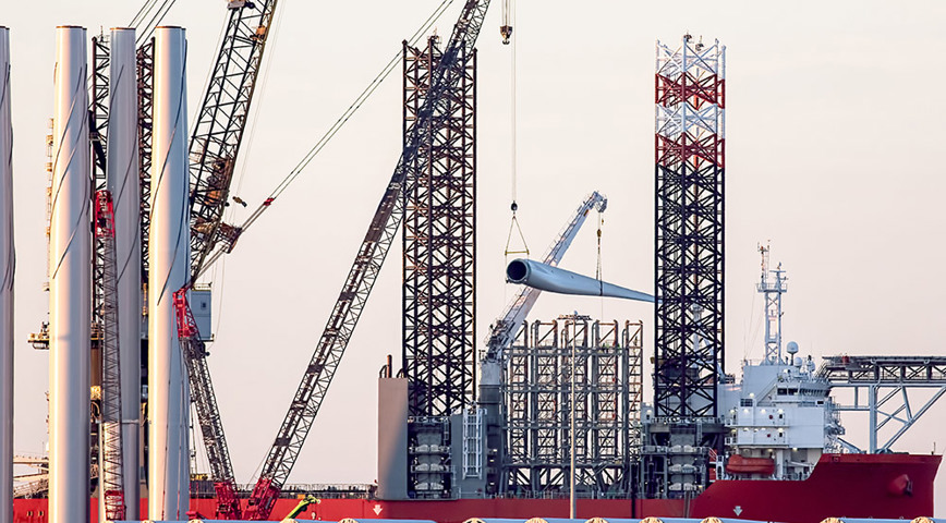 Offshore wind turbine blades and towers at a port in Great Yarmouth