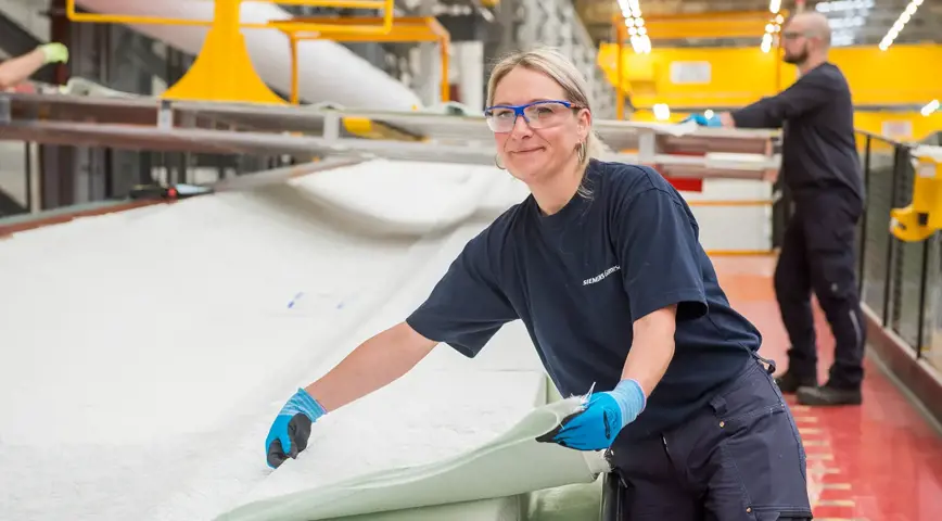 A woman making an offshore wind turbine blade at Siemens Gamesa Hull blade factory